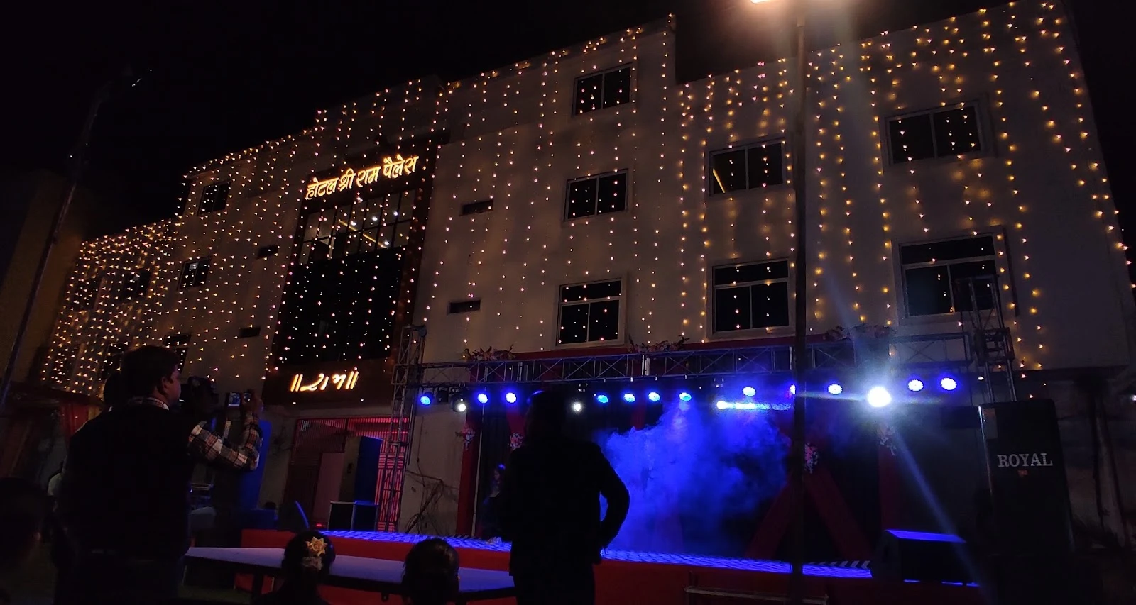 Exterior view of Hotel Shree Ram Palace decorated with lights.